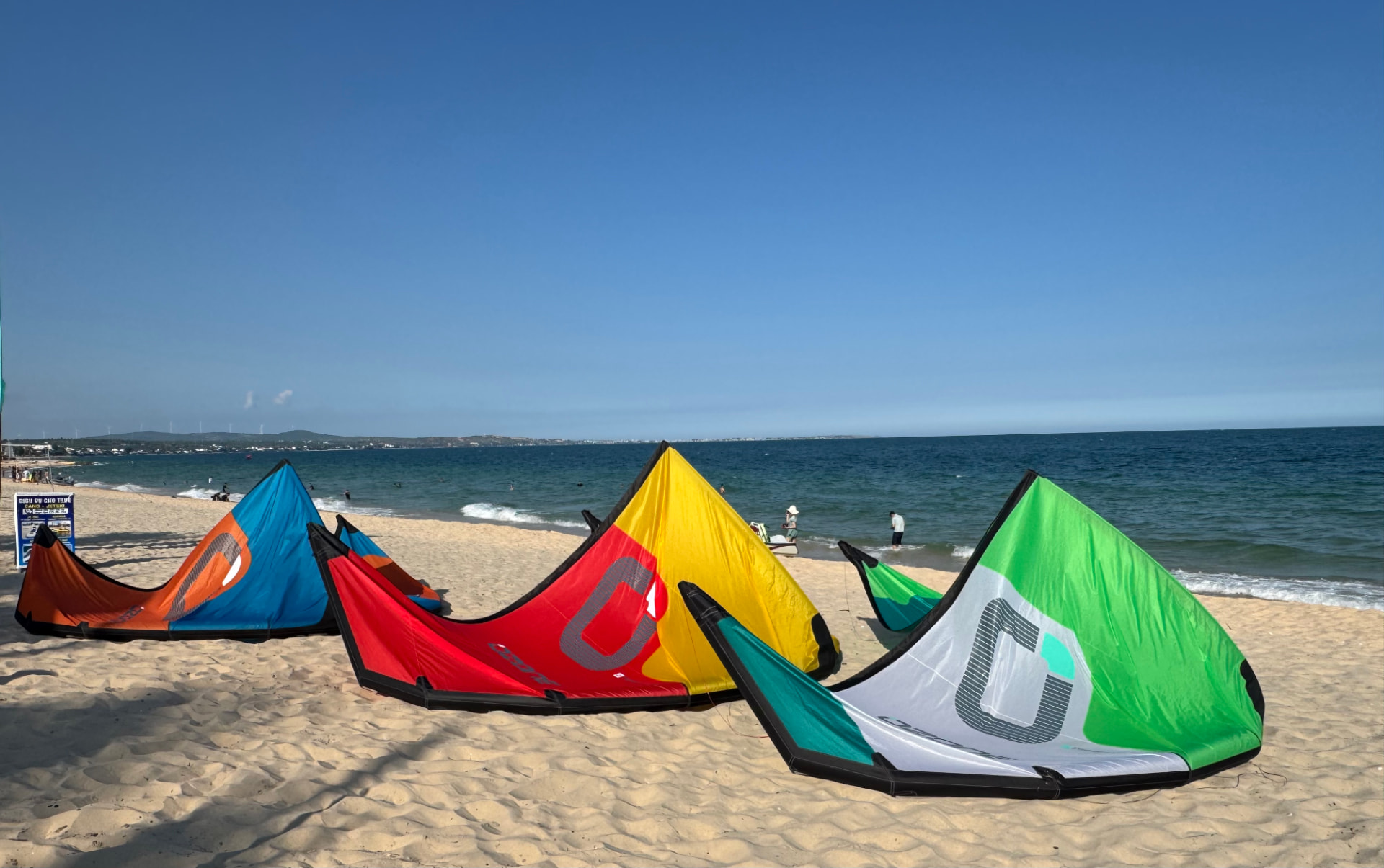 Kites laid out on the sand at Ham Tien beach before a session